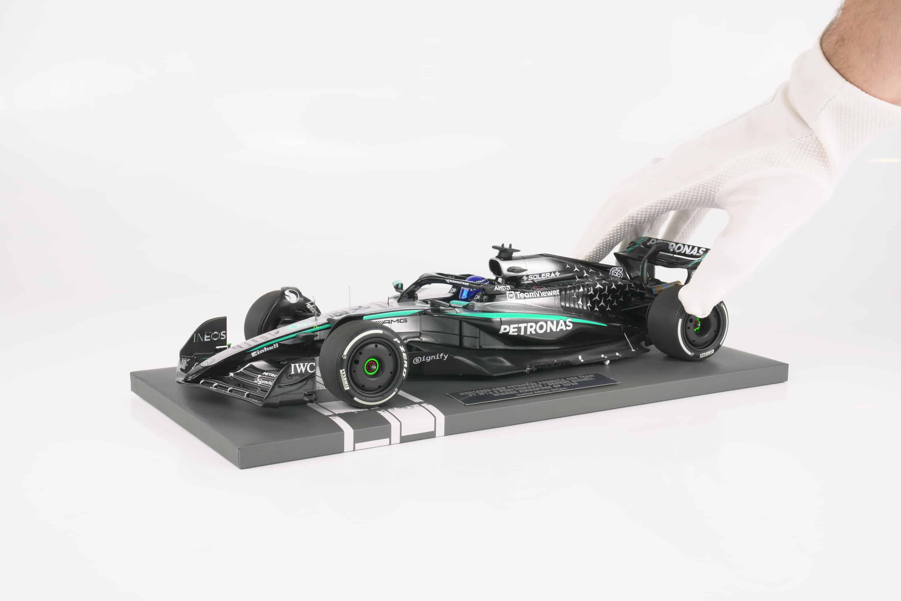 Minichamps 1:18 Mercedes-AMG Petronas F1 Team W16 E Performance No.63 George Russell Winner Singapore GP 2025 (117251863) Limited Edition Resin Model 4 Minichamps 1:18 Mercedes-AMG W16 E Performance No.63 George Russell Winner Singapore GP 2025 black silver resin model (117251863) - held in gloved hand to show scale