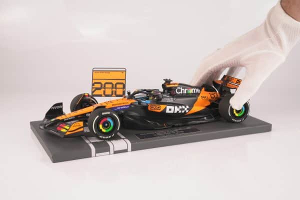 Minichamps 1:18 McLaren MCL39 No.81 Oscar Piastri 2nd Hungarian GP 2025 McLaren 200 GP Wins with Pit Board (537253181) Limited Edition Resin Model 12 Minichamps 1:18 McLaren MCL39 No.81 Oscar Piastri 2nd Hungarian GP 2025 resin model with 200 pit board (537253181), held in a white glove for scale